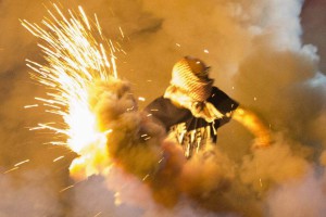 A protester throws back a smoke bomb while clashing with police in Ferguson, Missouri